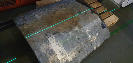 laser scan line is seen projected on the exterior surface of the tank wall sample