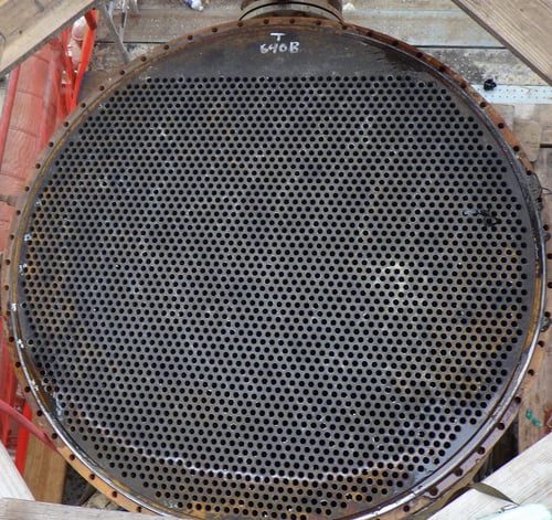 A large round metal object with holes
Description automatically generated